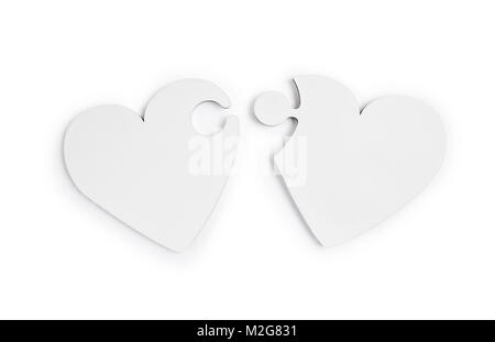 Deux coeurs puzzle sur masque de découpe isolé sur fond blanc, vue du dessus l'illustration pour la Saint-Valentin ou mariage Banque D'Images