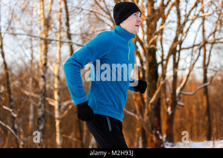 Photo de jeune athlète qui traverse la forêt d'hiver Banque D'Images