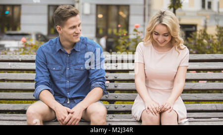 Blonde timide girl smiling, guy attrayant de flirter avec belle femme sur l'établi, la vidéo stock Banque D'Images