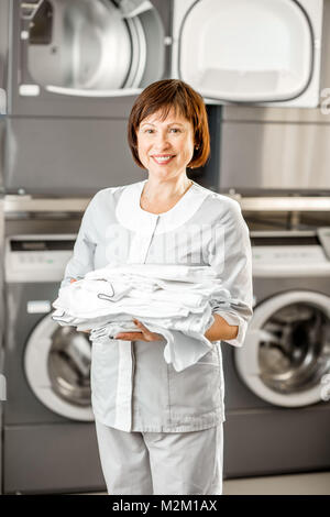 Washwoman senior dans la buanderie Banque D'Images