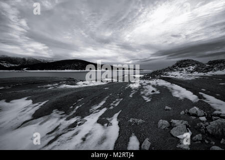 Contraste élevé noir et blanc paysage d'hiver sur la plage du lac de haute montagne couverte de neige Banque D'Images