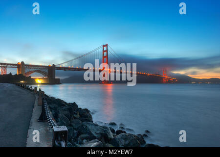 Le célèbre Golden Gate Bridge avec le Fort Point National Historic Site photographié après le coucher du soleil à partir de la baie de San Francisco à San Francisco, CA. Banque D'Images