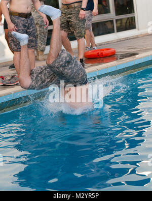 Un membre du 27e Bataillon de la Brigade de la police militaire des troupes spéciales de l'équipe plonge dans la piscine pour récupérer leurs équipes au cours de l'événement mystère brique du plongeur 250 Défi au Koweït Base Navale, le 14 juillet. L'événement mystère avait les équipes de sauter dans une piscine qui a été de plus de 12 pieds de profondeur tout en essayant de récupérer l'équipe de la brique bas afin qu'il puisse être effectué à la ligne d'arrivée. Le défi a été mise sur pied par l'Armée de terre 569e bataillon du génie (plongée) pour aider à bâtir esprit de corps entre les soldats et des services. (U.S. Photo de l'armée de l'armée par le Sgt. Peter J. Berardi, 316e Commandement de soutien (Expédit Banque D'Images