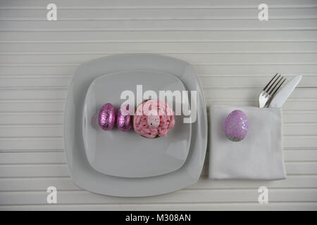 Table de pâques place mise en blanc avec décorations oeufs de Pâques et cupcake Banque D'Images