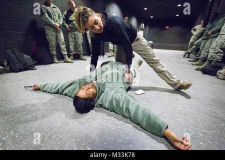 Ana Nichols, à genoux, instructeur soins tactiques au combat avec l'Armée de l'air 421e Escadron d'entraînement au combat, United States Air Force aérienne expéditionnaire Centre, montre comment arrêter le saignement d'artère fémorale sur un aviateur au New Jersey Army National Guard's formation conjointe et le développement de la formation de base commune au Centre McGuire-Dix-Lakehurst, N.J., le 2 février 2018. Les aviateurs sont étudiants à l'expéditionnaire Centre. La Garde nationale (New Jersey Banque D'Images