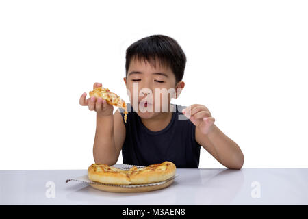 Cute boy est de fermer les yeux et avoir une saine alimentation pizza isolé sur fond blanc. Pizzeria peut être utilisé comme une illustration menu alimentaire. Banque D'Images