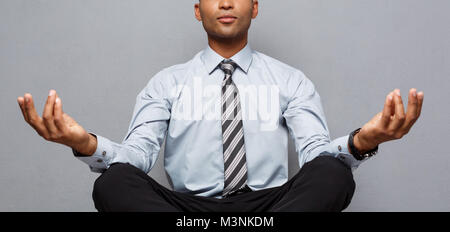 Concept d'affaires - portrait of african american businessman doing Meditation et Yoga yoga en avant de travailler. Banque D'Images