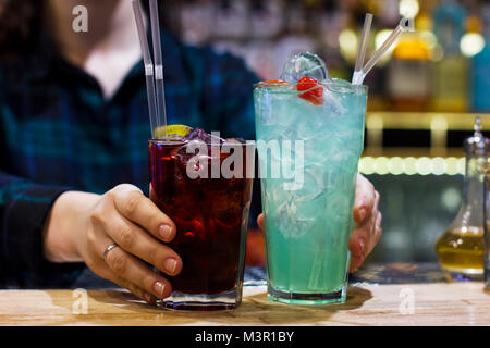 Le barman fille tenant deux verres sur le bar Banque D'Images