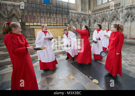 Les Choristes à partir de la cathédrale d'Ely dans le Cambridgeshire pratiquer pour ce qui est de la course de crêpes années lieu le Mardi Gras ( Feb 13) dans la cathédrale. Les Choristes ont été occupés à pratiquer pour la traditionnelle course de crêpes à la Cathédrale d'Ely dans le Cambridgeshire demain (mardi). Les filles, vêtus de leurs soutanes rouges, perfectionné leurs compétences pour lancer de crêpes l'événement annuel dans la Cathédrale du xiie siècle. Chaque année autour de 20 choristes de la Boys' and Girls' choirs dévalez la nef après la messe à l'occasion de Mardi Gras. Il est le troisième plus long nef au Royaume-Uni, mesure 75 mètres. Banque D'Images