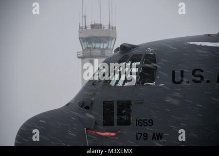 Travail sur le frein aviateurs systèmes d'un C-130H Hercules lors d'une tempête de neige, Février 07, 2018, à la 179e Airlift Wing, Mansfield, Ohio. La 179e Airlift Wing groupe maintenance inspecte régulièrement tous les aspects de leur avion pour maintenir l'état de préparation de la mission avec prêt d'aviateurs et de prêt des avions. (U.S. Air National Guard photo de Tech. Le Sgt. Joe HarwoodReleased) Banque D'Images