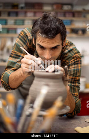 Ce jeune homme et la décoration de la Poterie en atelier Banque D'Images