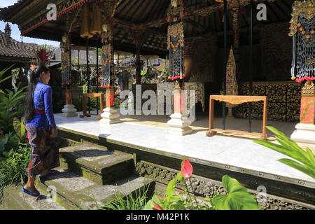 Une jeune fille en costume traditionnel local prier dans un temple balinais.Ubud Bali.L'Indonésie. Banque D'Images