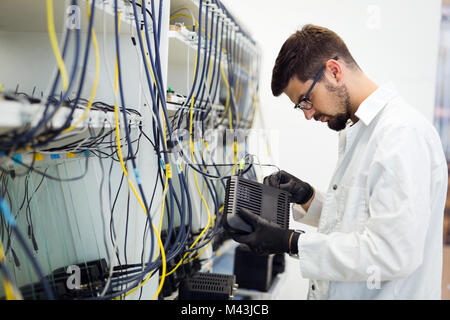 Photo de technicien réseau modems tests en usine Banque D'Images