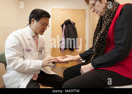 Chirurgien orthopédiste de l'examen d'une main du patient après la chirurgie de la maladie de Dupuytren sur son doigt et palm. Banque D'Images