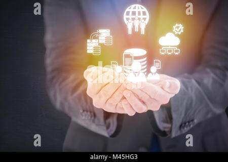 Image composite de handsome businessman presenting with hands Banque D'Images