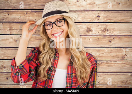 Image composite de gorgeous smiling blonde posing hipster Banque D'Images