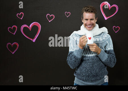 Composite image of happy man holding mug Banque D'Images