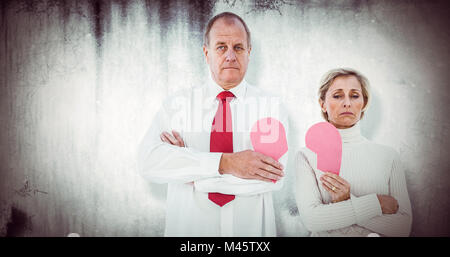 Image composite de vieux couple standing holding broken heart rose Banque D'Images