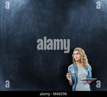 Image composite de woman holding eyeglasses and digital tablet Banque D'Images
