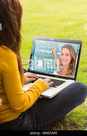 Image composite de woman using laptop in park Banque D'Images