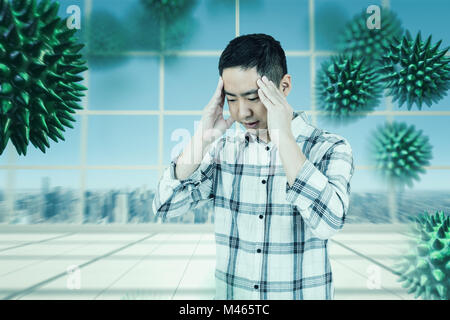 Image composite d'avoir un mal de tête Homme asiatique Banque D'Images