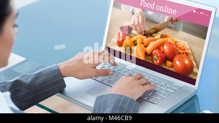 Image composite de businesswoman using laptop Banque D'Images