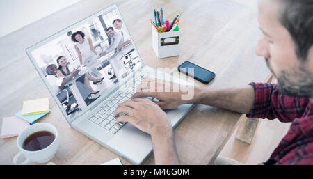 Image composite de creative businessman typing on laptop Banque D'Images