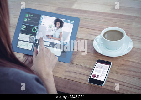 Composite image of businesswoman working on her laptop Banque D'Images