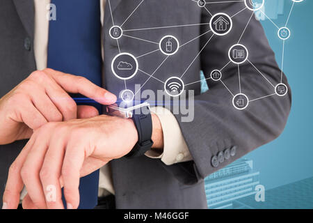 Image composite de businessman looking at watch Banque D'Images