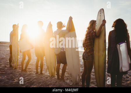 Happy friends standing in line avec des planches Banque D'Images