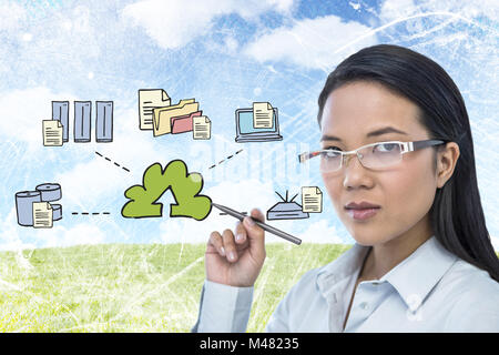 Image composite de l'attractive businesswoman holding pen Banque D'Images