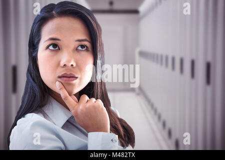 Composite image of businesswoman with finger on chin Banque D'Images