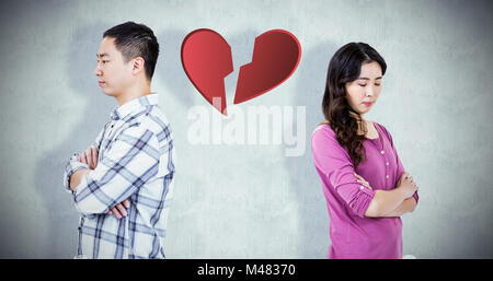 Image composite de colère couple standing with arms crossed Banque D'Images