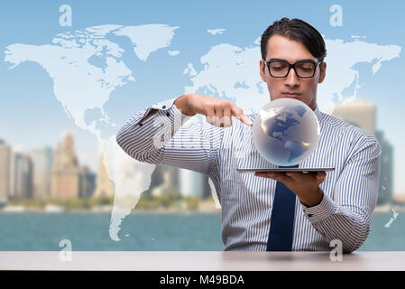 Businessman holding globe in global business concept Banque D'Images