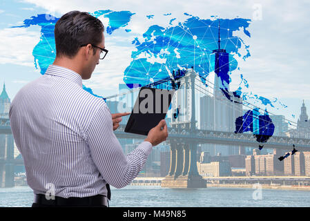 Businessman with tablet in global business concept Banque D'Images