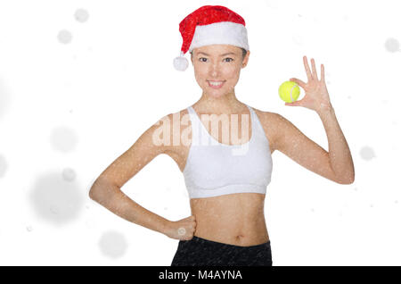 Asian woman holding balle de tennis dans la neige Banque D'Images