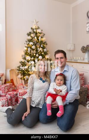 Les jeunes professionnels famille devant un arbre de Noël Banque D'Images