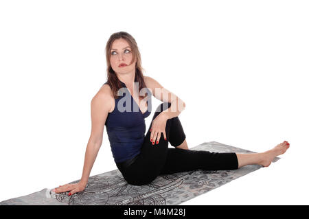 L'exercice de woman sitting on floor, de repos Banque D'Images