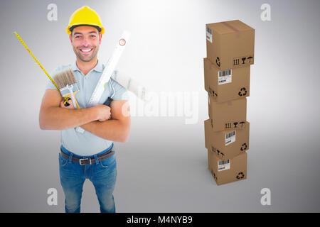 Image composite de portrait of happy worker holding divers outils manuels Banque D'Images