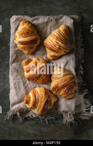 Des petits croissants traditionnels sur lin textile sur fond de métal sombre. Vue de dessus, de l'espace Banque D'Images