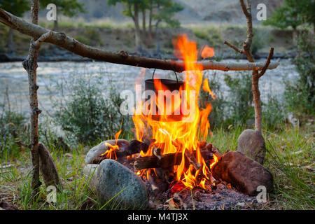 Dans un repas de cuisine électrique en brûlant , feu de camping sauvage Banque D'Images