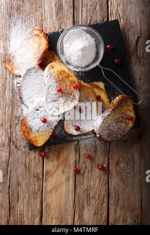 Sweet brésilien Rabanadas toast avec du sucre en poudre et les canneberges close-up sur la table. Haut Vertical Vue de dessus Banque D'Images