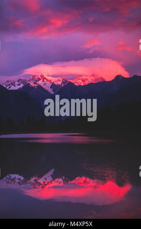 Coucher du soleil reflet de Mt Tasman et Mt Cook, Lake Matheson, Westland National Park, Île du Sud, Nouvelle-Zélande. Banque D'Images