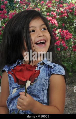 Little Girl Holding Rose Banque D'Images