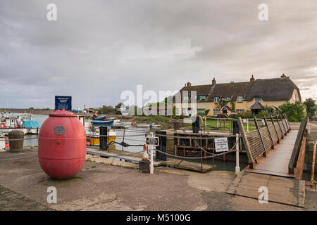 La collection de la Société des naufragés mine à Porlock Weir , Somerset, Angleterre avec la passerelle au-dessus des portes de l'écluse. Banque D'Images