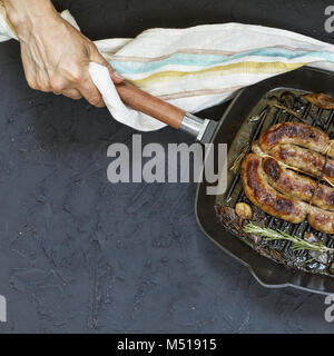 Des saucisses grillées servies par femme en mains Banque D'Images