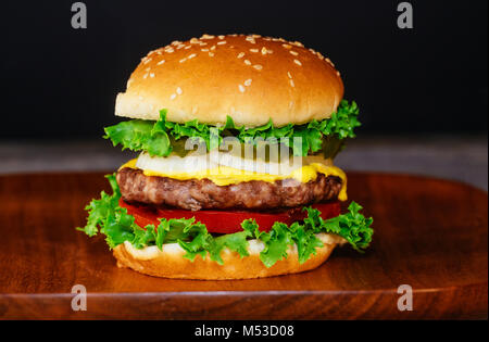 Close up delicious fresh burger hamburger fait maison sur planche de bois avec des légumes frais Banque D'Images