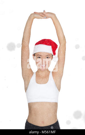 Belle asian woman in Santa's hat consiste en fitness Banque D'Images