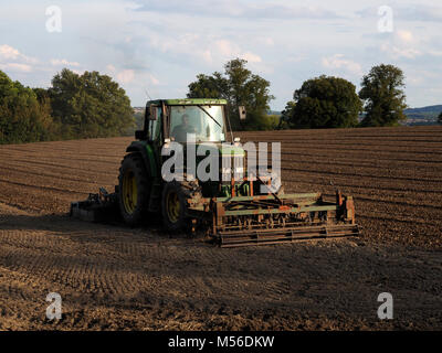 Tracteur agricole labourant champ dans le Derbyshire, Angleterre Banque D'Images