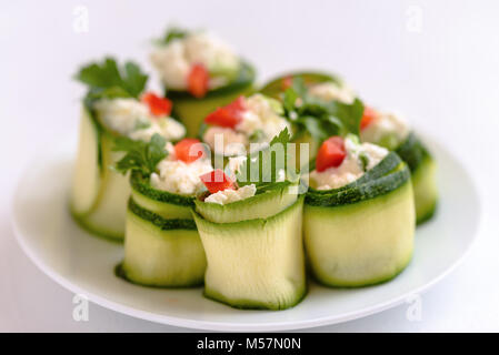 Rouleaux de courgettes farcies au fromage et ciboulette et paprika rouge. Banque D'Images